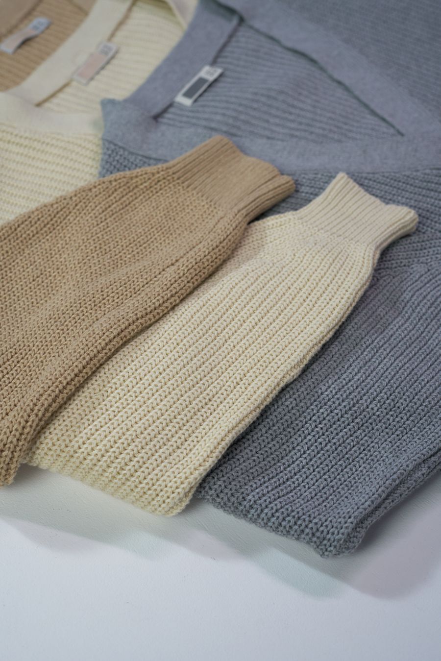 Folded knit sweaters in earthy tones